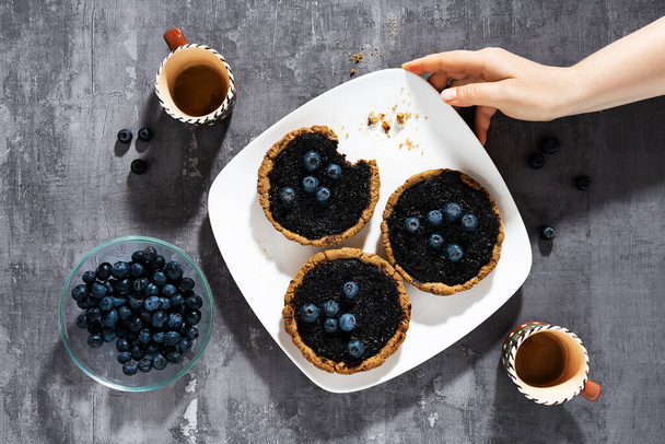 small italian crostata cakes with blueberry jam on a plate and coffee - Fotoğraf, Görsel