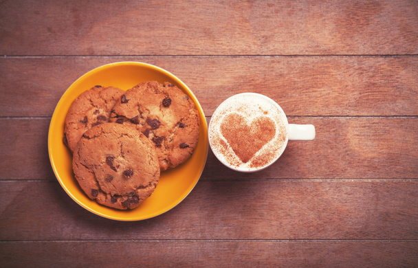 Cookie and cup of coffee on wooden table.  - Fotografie, Obrázek