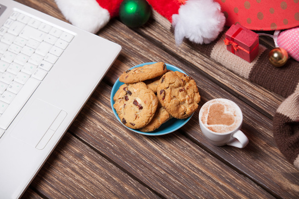 laptop and cookies wuth cup of coffee near christmas gifts. - Photo, Image