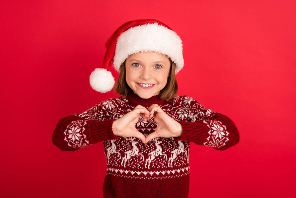 Photo of young small girl happy positive smile show hands heart figure love isolated over red color background - Fotografie, Obrázek