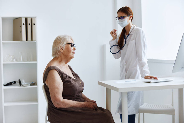doctor in medical mask patient examination medical specialist - Photo, Image