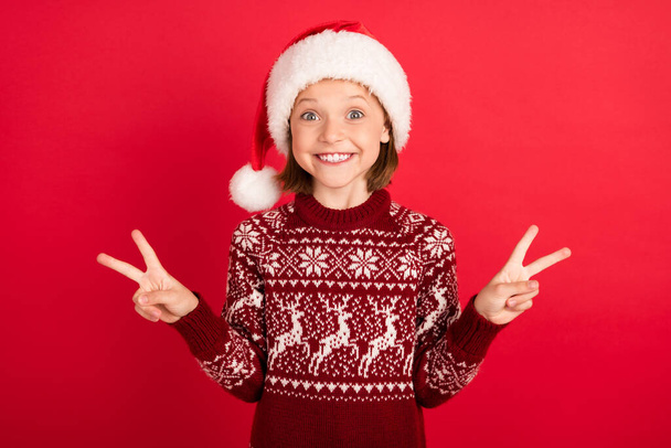 Portrait of attractive funky cheerful girl showing double v-sign having fun eve newyear isolated over bright red color background - Foto, imagen