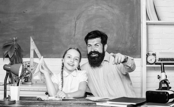 Inspired to work hard. private lesson. back to school. Private teaching. knowledge day. Home schooling. daughter study with father. Teachers day. girl child with bearded teacher man in classroom - Fotografie, Obrázek