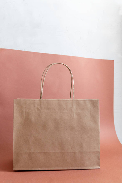 papírová taška zesměšňovat proti bílému a hnědému pozadí - Fotografie, Obrázek
