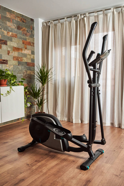 Elliptical cross training machine in the living room of the house - Photo, Image