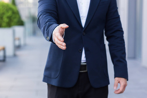 Close-up photo of greeting male businessman handshake in business suit - Foto, immagini