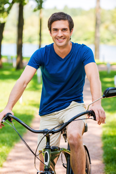 Man riding bicycle in park - 写真・画像