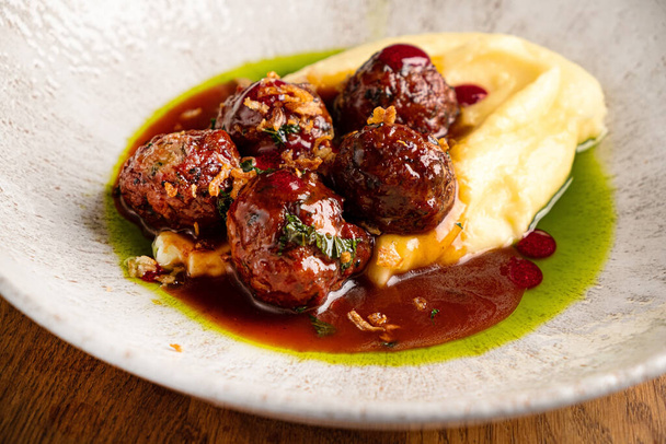 beef meatballs with mashed potato and cranberry sauce - 写真・画像