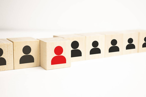 Wooden cube blocks with icon people standing out from the crowd with a woman leader in red. - Fotoğraf, Görsel