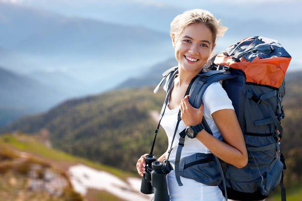 female traveler with backpack in mountains  - 写真・画像