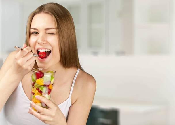 Young woman eat salad. Home concept. Healthy lifestyle concept. - Fotó, kép