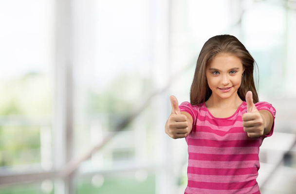 cute little girl with thumbs up - 写真・画像