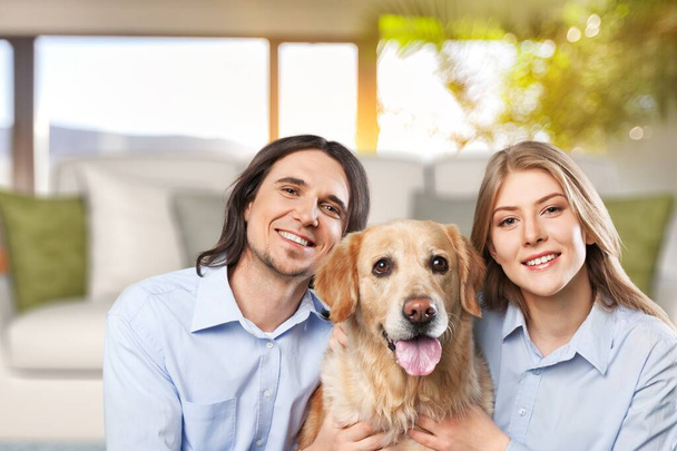 Love And Care Concept. Portrait of cheerful couple patting their dog - Foto, Bild