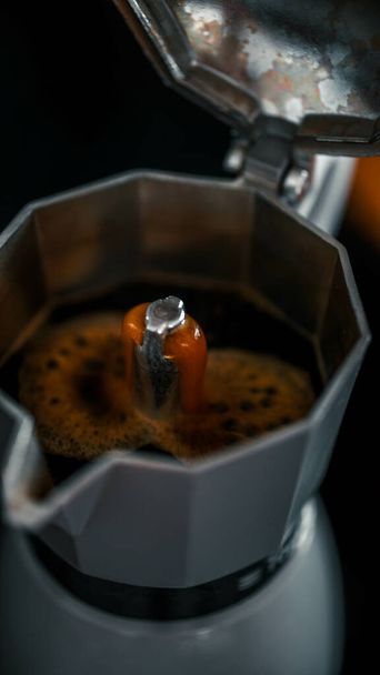 A vertical shot of an Italian espresso being prepared in a machine - Fotó, kép