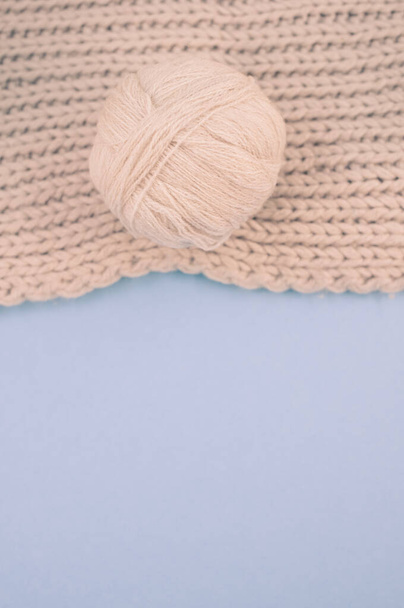 hand knitted soft wool on a cyan background with copy space - Foto, imagen
