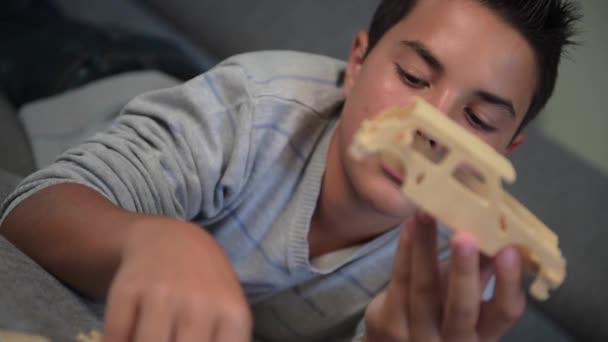 Child making mounting a car model at home - Filmmaterial, Video