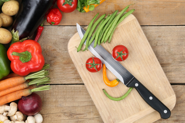 Preparing food smiling vegetables face on cutting board - Фото, зображення