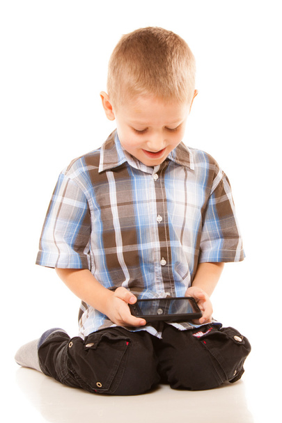 Little boy playing games on smartphone - Photo, image