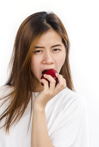 Молода жінка їсть яблуко
. - Фото, зображення