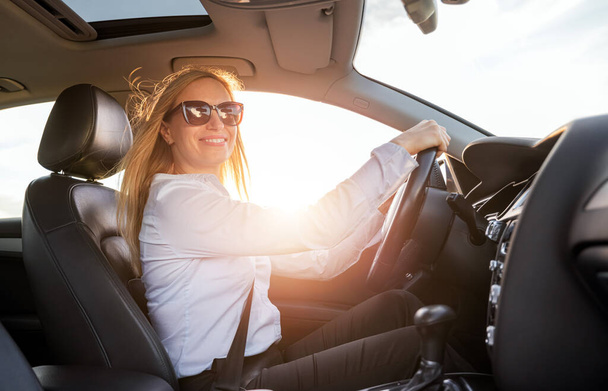Smiling business woman driving car - Photo, Image