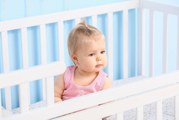 Cute baby girl in cot at home - Photo, Image