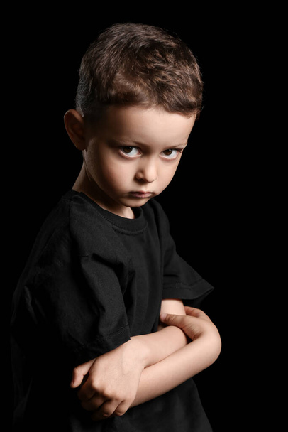Portrait of cute little boy on dark background - Photo, Image