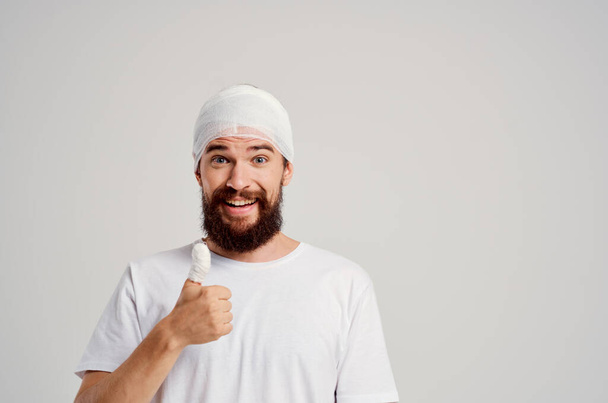patient with a bandaged head and thumb on  isolated background. High quality photo - Photo, Image