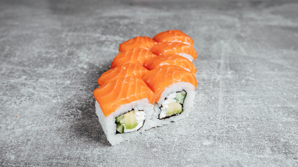 Philadelphia Classic sushi rolls on stone texture table  - Фото, изображение