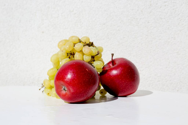 green grapes and red apples in the white background - Photo, image