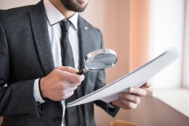 business man holding magnifier and documen - Photo, Image