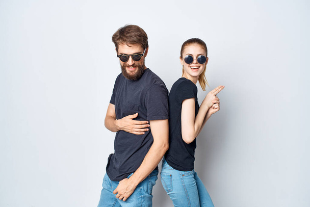 married couple in black t-shirt sunglasses posing light background - Foto, Imagen