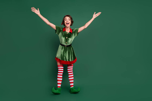 Photo of crazy funky friendly lady hands invite hug wear elf costume hat stockings isolated green color background - Valokuva, kuva