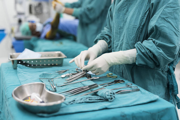 scrub nurse preparing medical instruments for operation - Foto, imagen