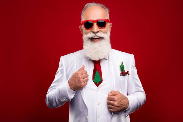 Photo of funky cool mature man dressed white christmas costume dark glasses smiling isolated red color background - Fotografie, Obrázek