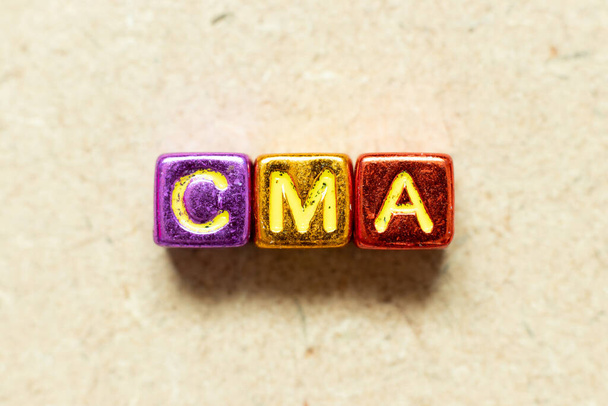 Metallic kleur alfabet letter blok in woord CMA (Afkorting van Certified management accountant, Competition and markets authority of Certified medical assistant) op hout achtergrond - Foto, afbeelding