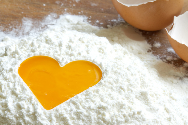 Yolk egg in flour love baking concept - Fotó, kép