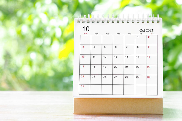 October 2021 Calendar desk for organizer to plan and reminder on wooden table on nature background. - Φωτογραφία, εικόνα