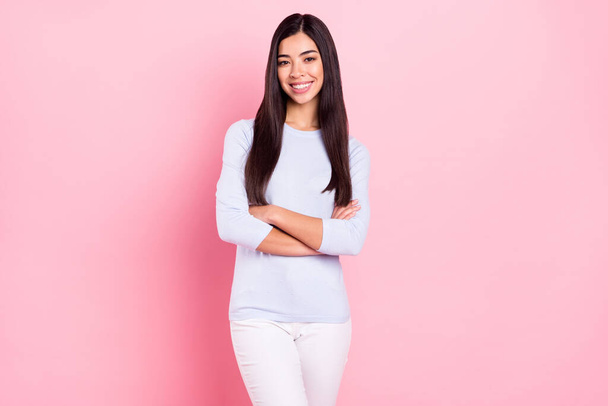 Photo portrait of girl with folded hands in blue shirt smiling happy successful freelancer isolated on pastel pink color background - Fotó, kép