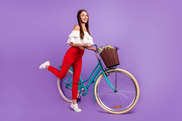 Photo of carefree dream lady ride bike stand tiptoe wear white blouse trousers sneakers isolated violet color background - Φωτογραφία, εικόνα