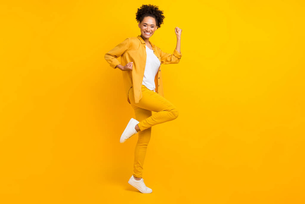 Full body profile side photo of young excited african girl celebrate victory achievements isolated over yellow color background - Fotografie, Obrázek
