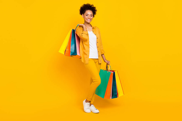 Full length body size photo woman got packages on sale isolated vivid yellow color background - Zdjęcie, obraz