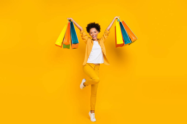 Full length body size photo woman keep packages overjoyed isolated vivid yellow color background - Fotografie, Obrázek