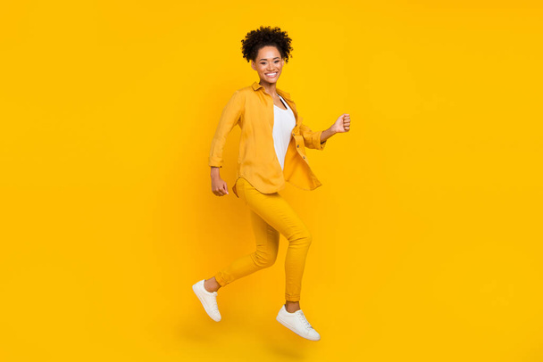 Full length body size photo woman jumping up running on sale isolated vibrant yellow color background - Foto, imagen