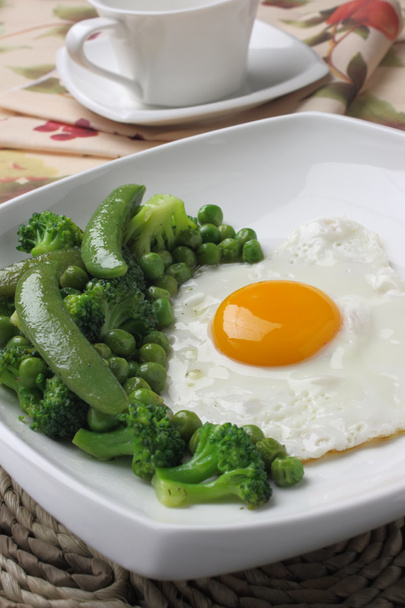 Fried egg with broccoli and green peas - Photo, image