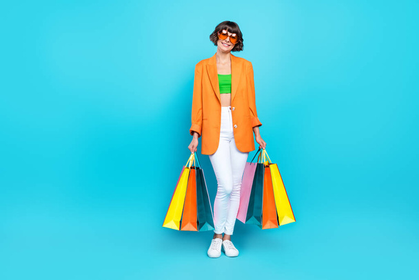 Full body photo of happy cheerful woman shopping bags good mood smile isolated on pastel blue color background - Φωτογραφία, εικόνα