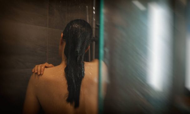 Woman washing herself in the shower. - Φωτογραφία, εικόνα