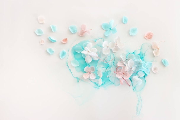 Creative image of pastel blue and pink Hydrangea flowers on artistic ink background. Top view with copy space - Photo, Image