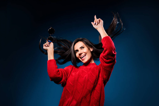Photo of adorable charming young woman dressed red pullover dancing pointing finger smiling isolated dark blue color background - Zdjęcie, obraz