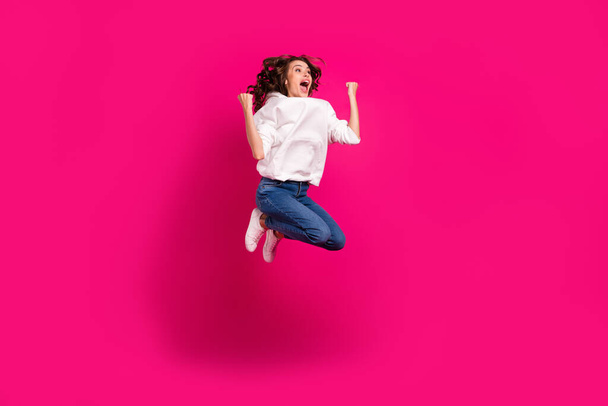 Photo of astonished lady jump celebrate victory scream goal wear white hoodie isolated pink color background - Photo, image
