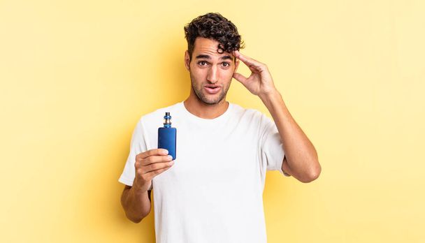 hispanic handsome man looking happy, astonished and surprised. vaporizer concept - Photo, Image